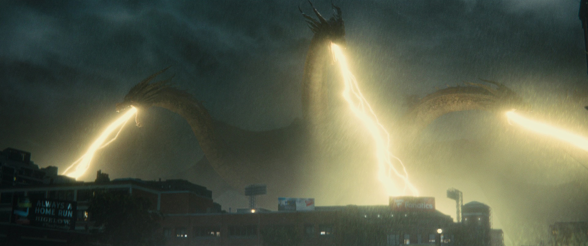 Cả ba đầu của King Ghidorah đồng loạt phóng ba luồng Tia Trọng Lực (Gravity Beams) vàng rực xé toạc màn đêm